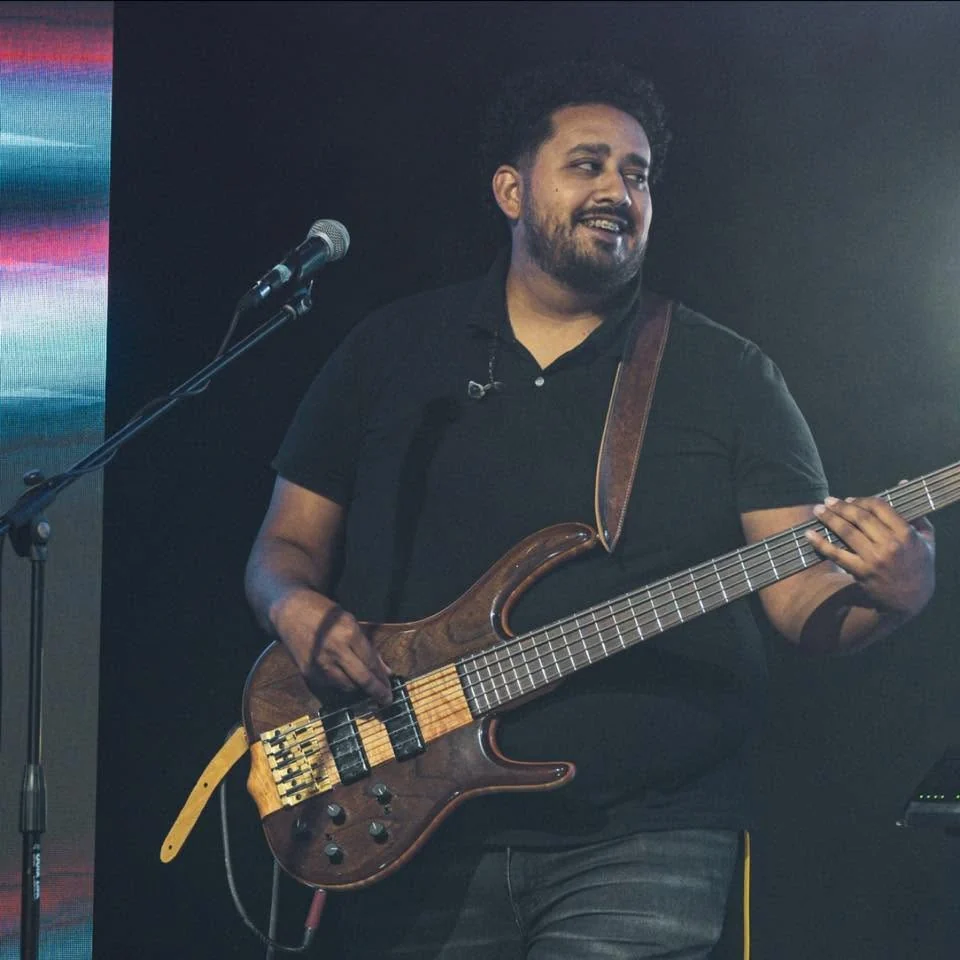 Adrian Jonathan performing bass on stage