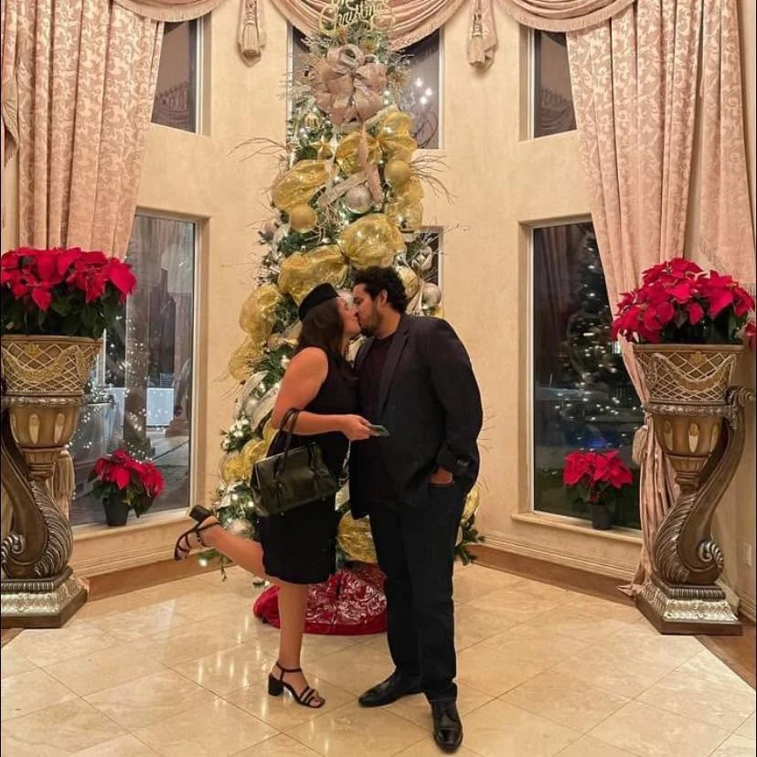 Personal photograph of Adrian with his wife during a holiday celebration
