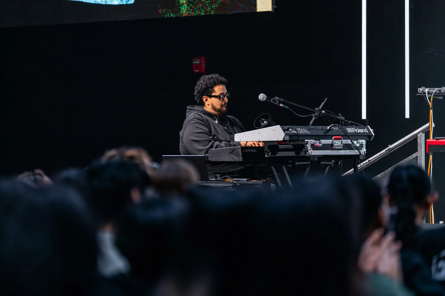 Adrian Jonathan performing keyboards with an audience in the foreground