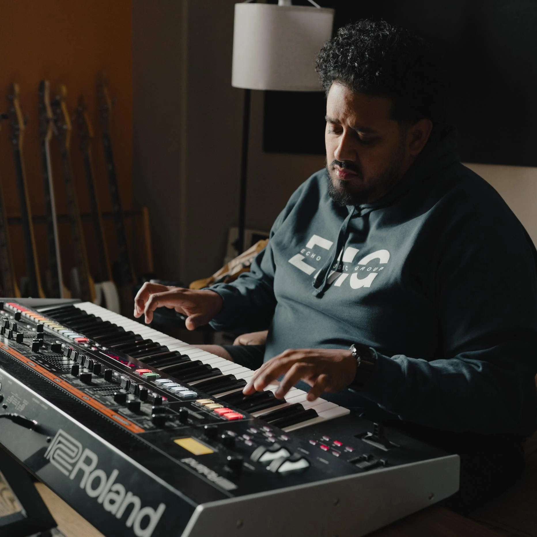 Adrian Jonathan playing keys in the studio